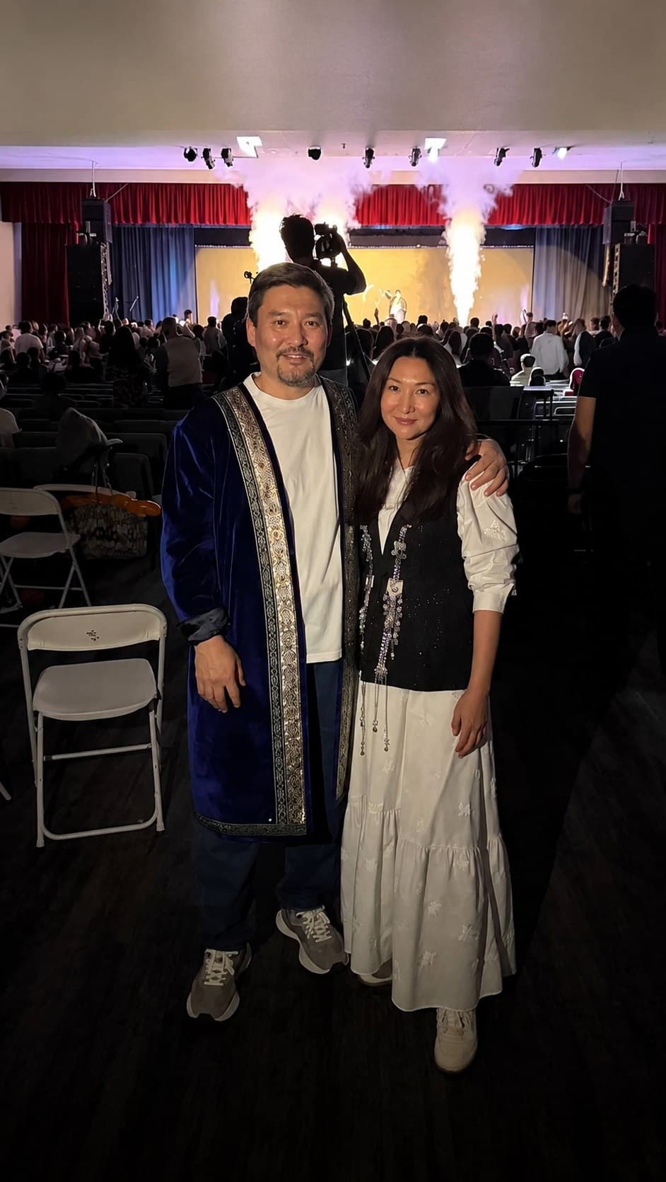 Askhat and his wife — owners of HappyCake — at a community event in traditional Kazakh dress